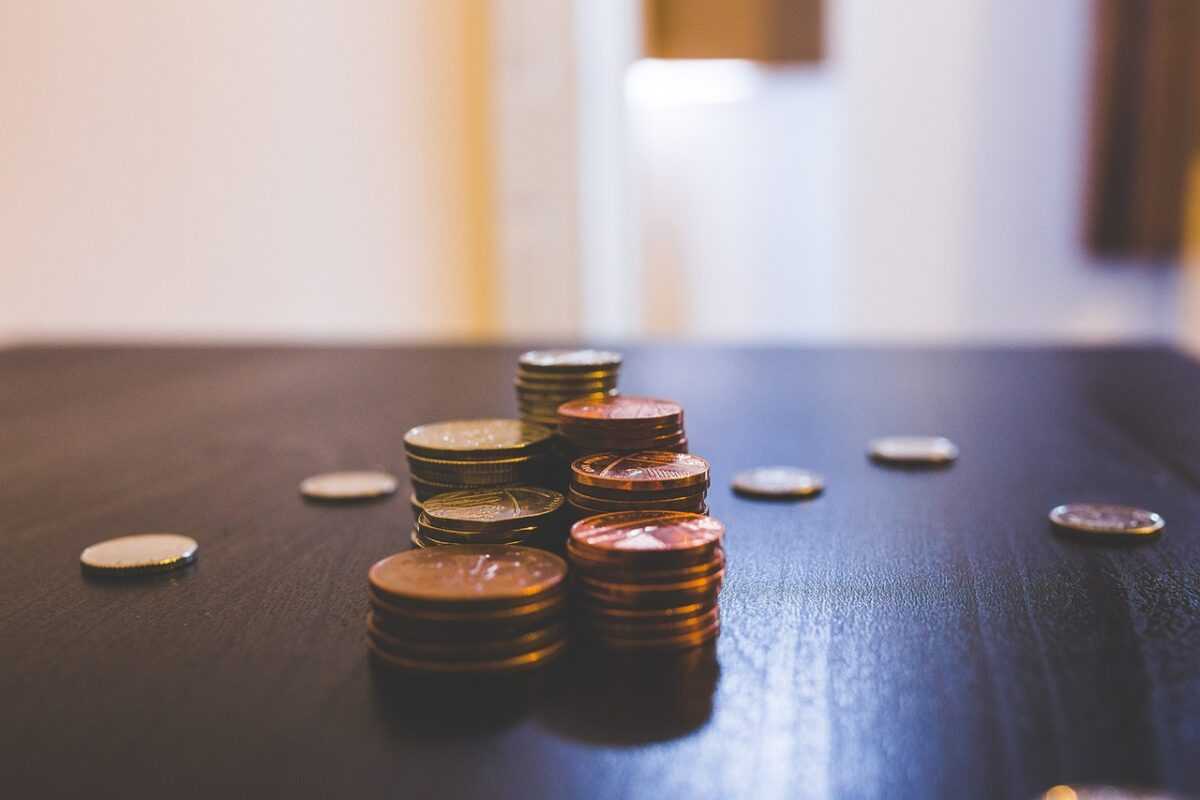 blur, bronze, coins, color, currency, indoors, money, stack of coins, table