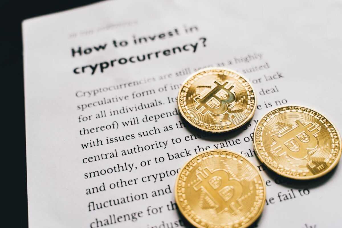 Close-up of Bitcoin coins on an investment guide paper.