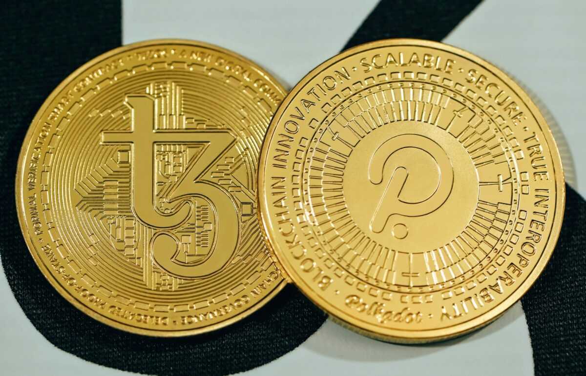 a close up of two gold coins on a black and white background